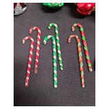 6 glass candy canes and Christmas ornaments.