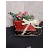 Christmas ornaments, string lights, sleigh decor.