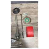 Collection of hardware items including metal fasteners, threaded rods, grinding wheel, metal hook tool, screws, palm sander and more
