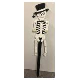 Halloween Plastic Pumpkin Candy Buckets, a small pumpkin stuffed character, and a skeleton yard decoration (see all pics)