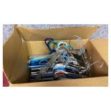 Box of clothing hangers - mostly plastic, a few pant hangers