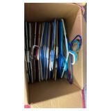Box of clothing hangers - mostly plastic, a few pant hangers