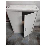 White Metal Storage Cabinet with Adjustable Shelves. 25"W x 12"D x 30"H  wall mountable.  Some patina and finish wear (dirt inside shelves)