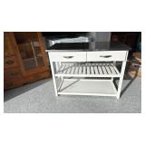 White kitchen island with metal top and 2 drawers 33x44x21 has electrical outlet