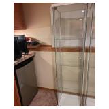 Glass display cabinet, about 64x17x14, located in basement, matches lot 802