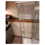 Glass display cabinet, about 64x17x14, located in basement, matches lot 802