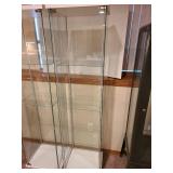 Glass display cabinet, about 64x17x14, located in basement, matches lot 801