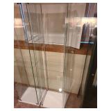 Glass display cabinet, about 64x17x14, located in basement, matches lot 801
