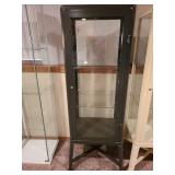 Metal and glass dark brown locking display cabinet, about 64x17x14, located in basement