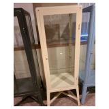 Metal and glass off-white locking display cabinet, about 64x17x14, located in basement