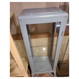Metal and glass dusty blue locking display cabinet, about 64x17x14, located in basement