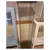 Glass display cabinet, about 64x17x14, located in basement