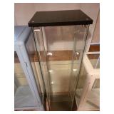 Glass display cabinet, about 64x17x14, located in basement
