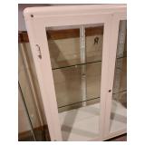 Metal and glass 2 door white locking display cabinet, about 44x32x16, located in basement