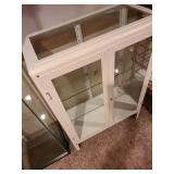 Metal and glass 2 door white locking display cabinet, about 44x32x16, located in basement