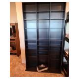 Black wall shelves 72x40x6, with extra shelves and pegs, located in basement