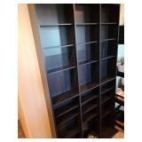 Black wall shelves 72x40x6, with extra shelves and pegs, located in basement