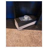 Black wall shelves 72x40x6, with extra shelves and pegs, located in basement