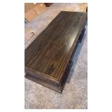Coffee table with side storage 15x60x24 located in basement