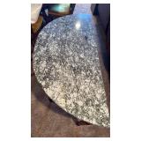 Half moon entry table with stone top 31x47x21.5 located in basement