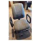 Office chair with handles located in basement