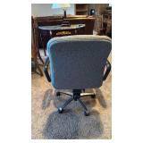 Office chair with handles located in basement