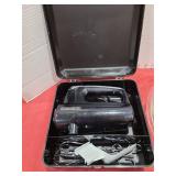 Hand mixer in case and a large mixing bowl.