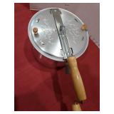 Aluminum stovetop hand-crank popcorn popper.
