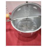 Aluminum stovetop hand-crank popcorn popper.