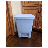 Blue plastic step-on trash can