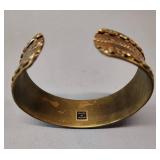 multi-strand beaded necklace with turquoise and wood crosses, paired with a copper brass cuff bracelet.