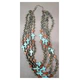 multi-strand beaded necklace with turquoise and wood crosses, paired with a copper brass cuff bracelet.