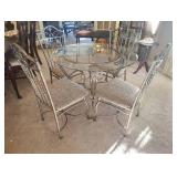 WROUGHT IRON DINING TABLE with a GLASS TOP and FOUR CHAIRS