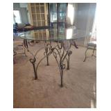WROUGHT IRON DINING TABLE with a GLASS TOP and FOUR CHAIRS
