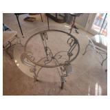 WROUGHT IRON DINING TABLE with a GLASS TOP and FOUR CHAIRS