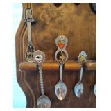 COLLECTION OF SOUVENIR SPOONS AND WOOD SPOON HOLDER