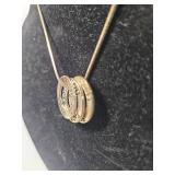 Gold Tone Necklace with Triple Ring Pendant