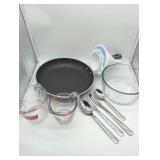 Multiple cooking items, see lot images. Anchor Hocking Glass Measuring Cup Set of 2, 10 1/2 inch wide skillet, 1 set silverware, 3 funnels, & 1 glass 7 cup microwave safe glass bowl. Used, as is.