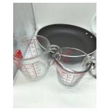Multiple cooking items, see lot images. Anchor Hocking Glass Measuring Cup Set of 2, 10 1/2 inch wide skillet, 1 set silverware, 3 funnels, & 1 glass 7 cup microwave safe glass bowl. Used, as is.