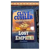 Clive Cussler hardcover books 2, and 1 hard cover book by Harlan Coben