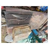 Steel table, metal storage box, pick axe, grate -- BY