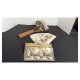 Antique hand-held wooden stereoscope viewer with picture cards