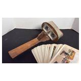 Antique hand-held wooden stereoscope viewer with picture cards