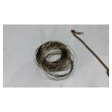 Lapel clasp and stack of bangles