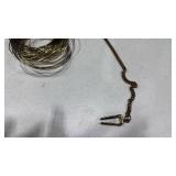 Lapel clasp and stack of bangles