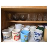 Kitchen Cabinet Collection with Decorated Teapot, Coffee Mugs, Carafes, Spice Rack, and More