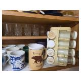 Kitchen Cabinet Collection with Decorated Teapot, Coffee Mugs, Carafes, Spice Rack, and More