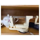 Kitchen Cabinet Collection with Decorated Teapot, Coffee Mugs, Carafes, Spice Rack, and More
