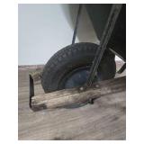 Black Wheelbarrow with Wooden Handles (bucket is cracked and tire need air or replaced) Black Wheelbarrow with Wooden Handles (bucket is cracked and tire need air or replaced)