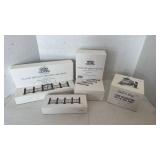 Department 56 Snow Village Collection kids decorating the village sign and fencing